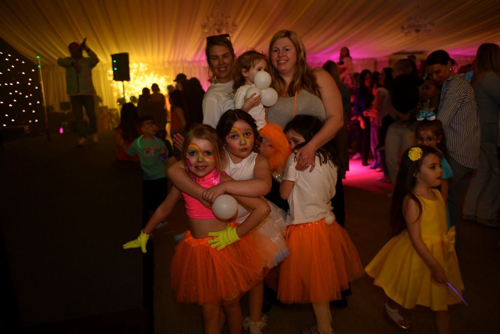Girls in neon with parents