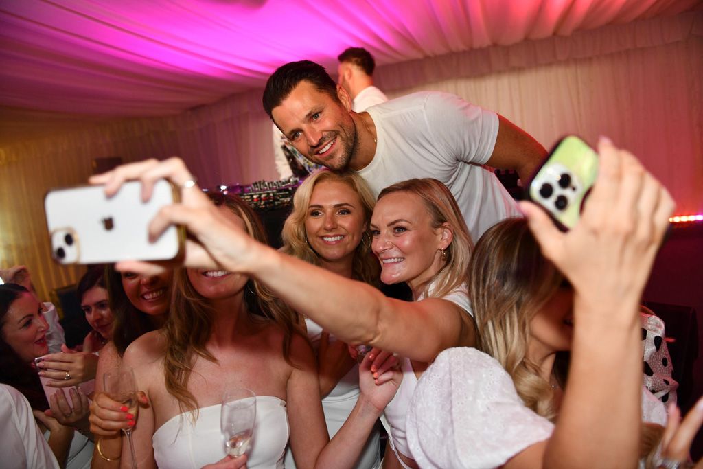 Two girls taking selfie with Mark Wright