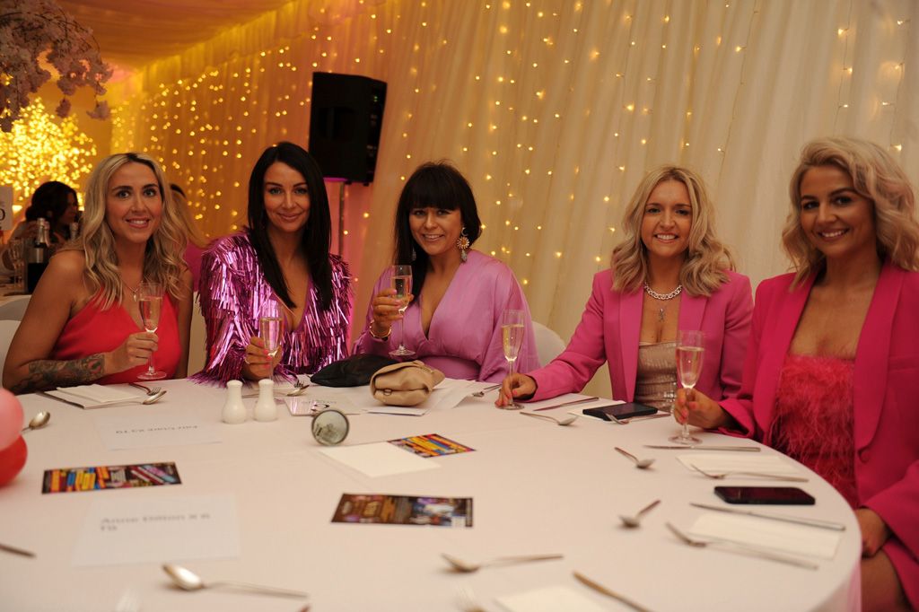 Five ladies at dinner table with fizz