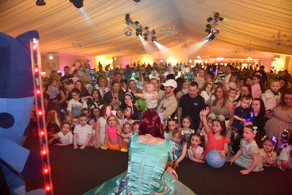 Disney princess facing crowd of kids