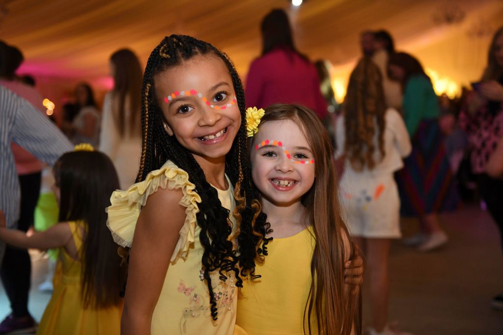 Two smiling little girls in yellow
