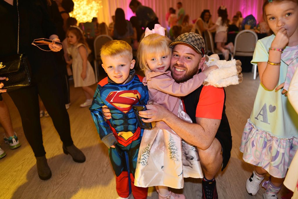 Dad with little girl and superman boy