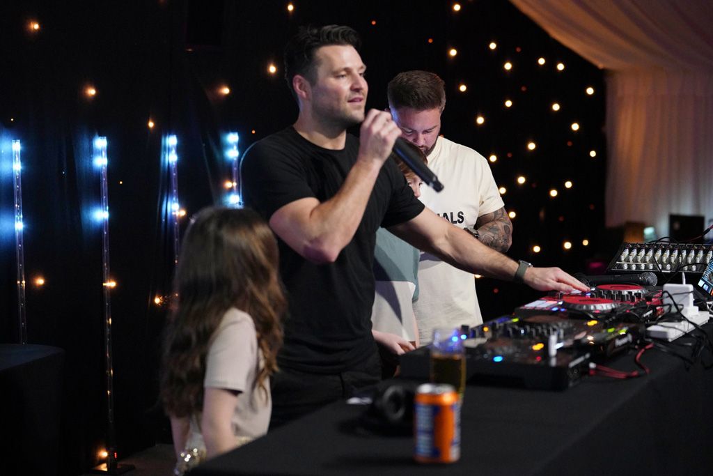 Mark Wright on the mic next to child