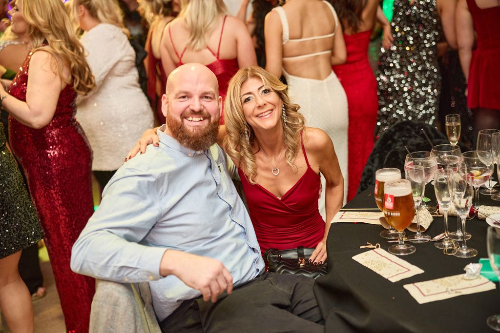 Festive couple smiling at table