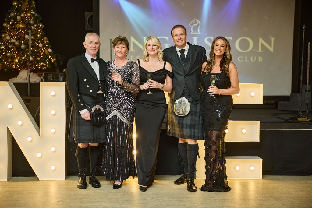 Kilted men and family in front of large New Year lighting