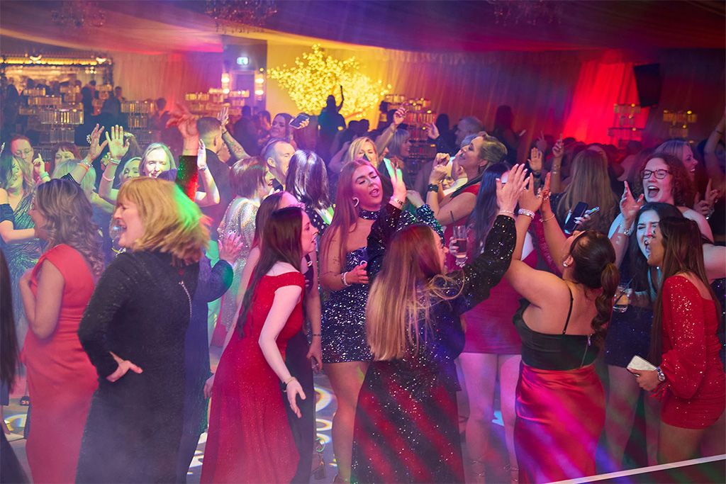 Crowd in festive clothing dancing