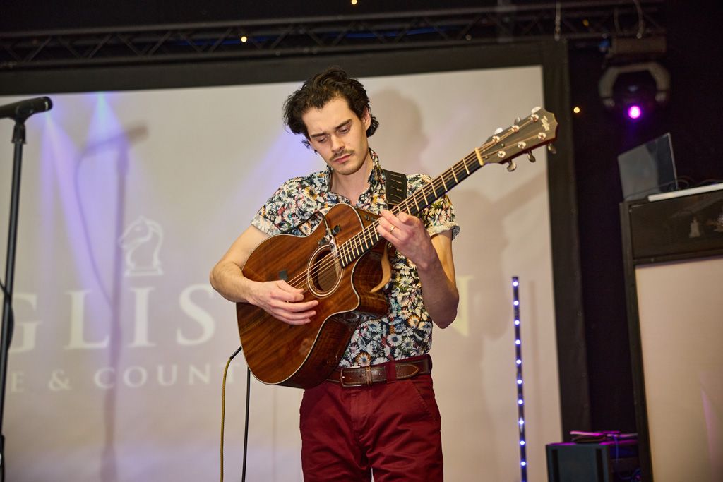 Male guitarist on Ingliston stage