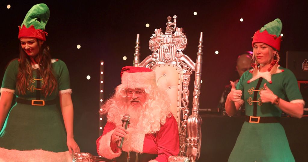 Santa and elves on stage