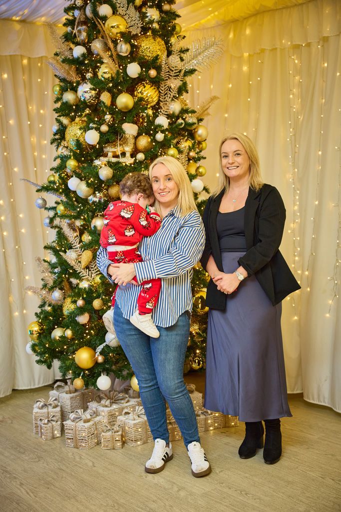 Mums in front of Christmas tree