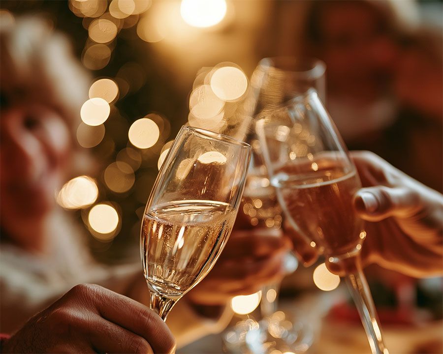 Toasting champagne with sparkles in background