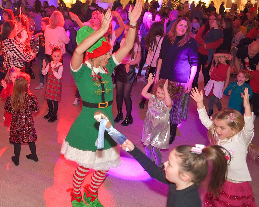 Elf, kids and parents dancing